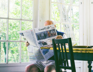 Older gentleman reading a newspaper