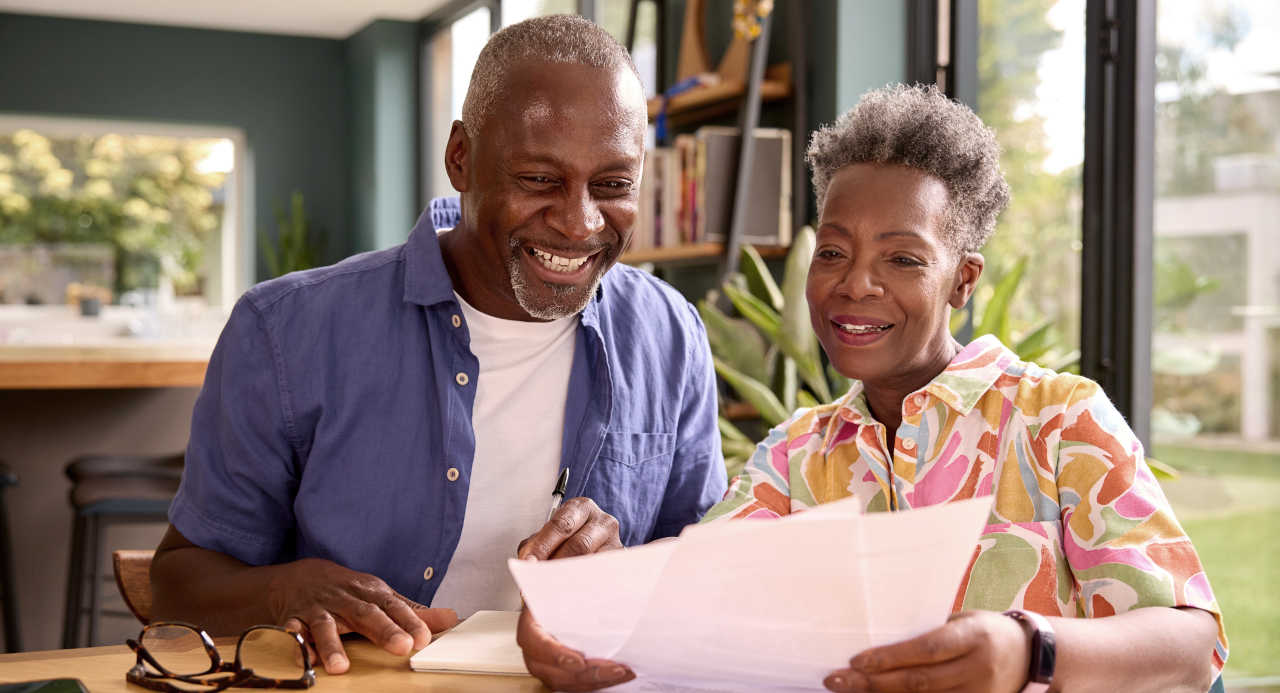 Smiling couple planning for retirement savings