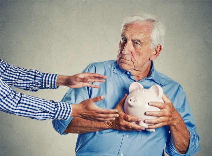 senior man grandfather holding piggy bank looking suspicious trying to protect his savings from being stolen