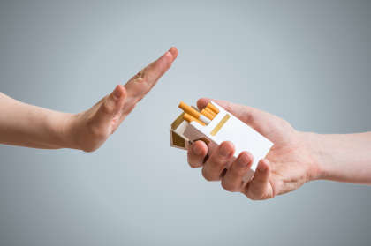 Hand refusing offer of cigarettes.