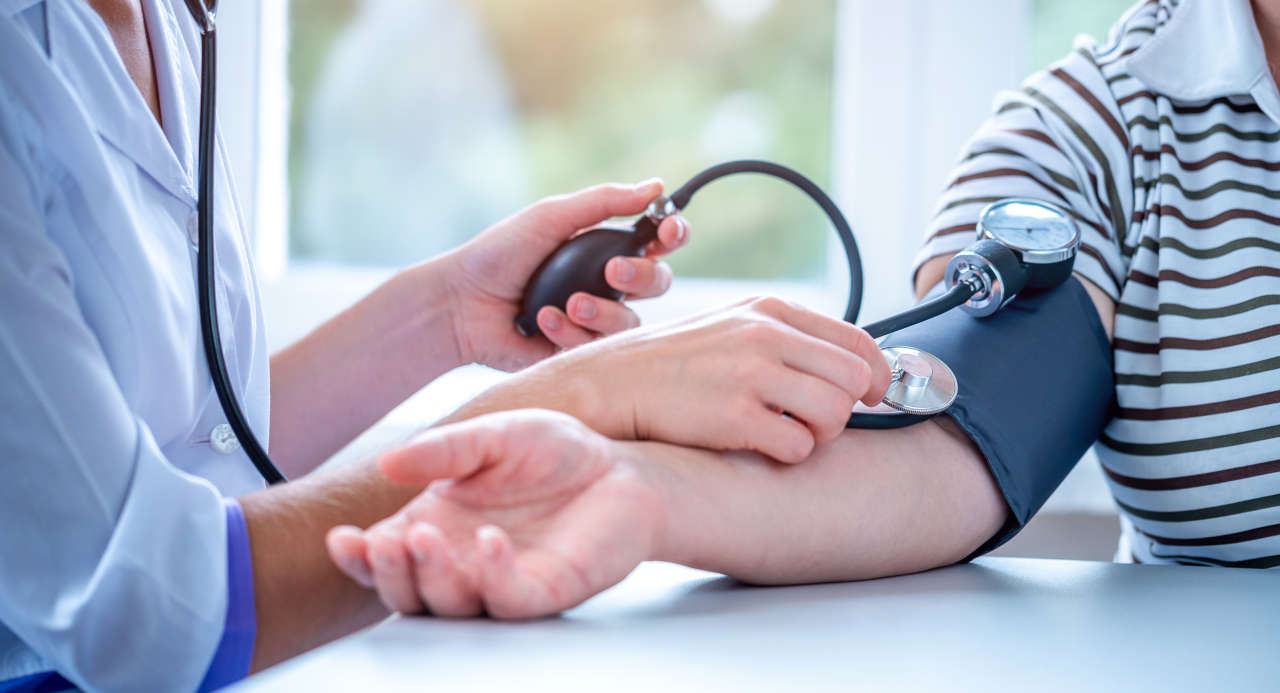 Doctor measuring the blood pressure of a patient with hypertension