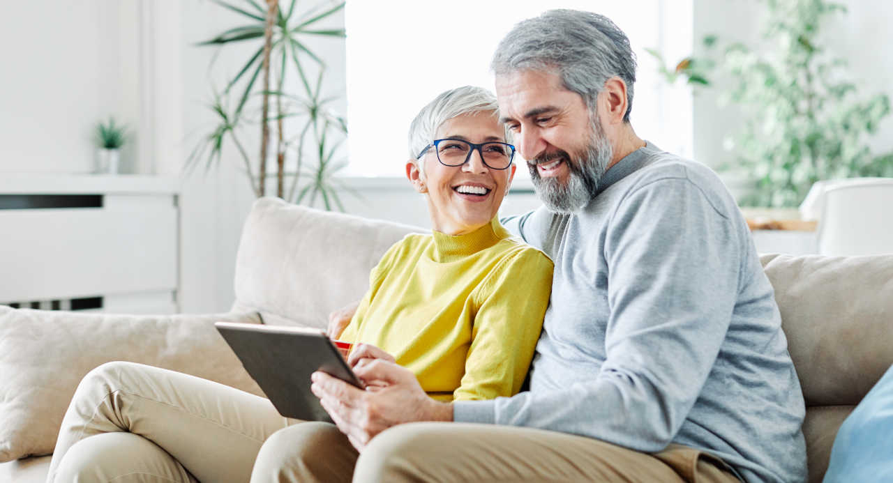 Senior couple using social media on a tablet
