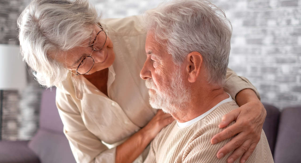 Senior woman comforting her husband with bipolar disorder