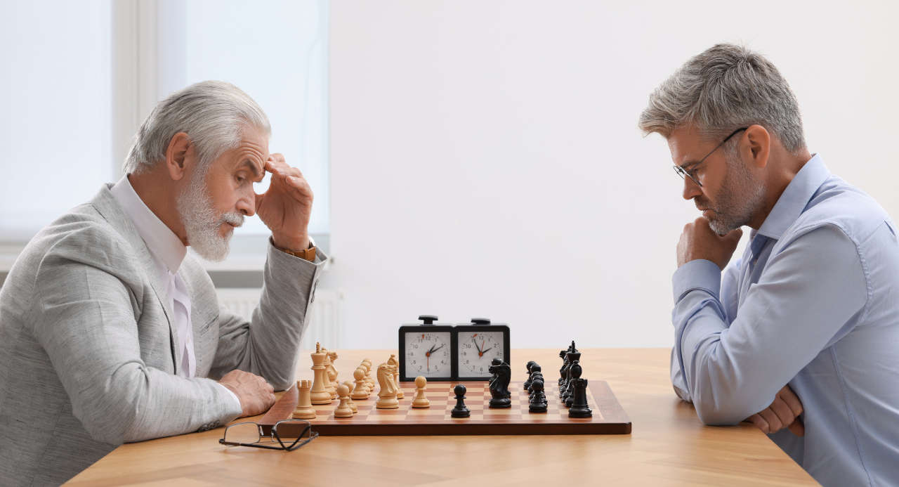 Two senior men playing chess to slow cognitive decline