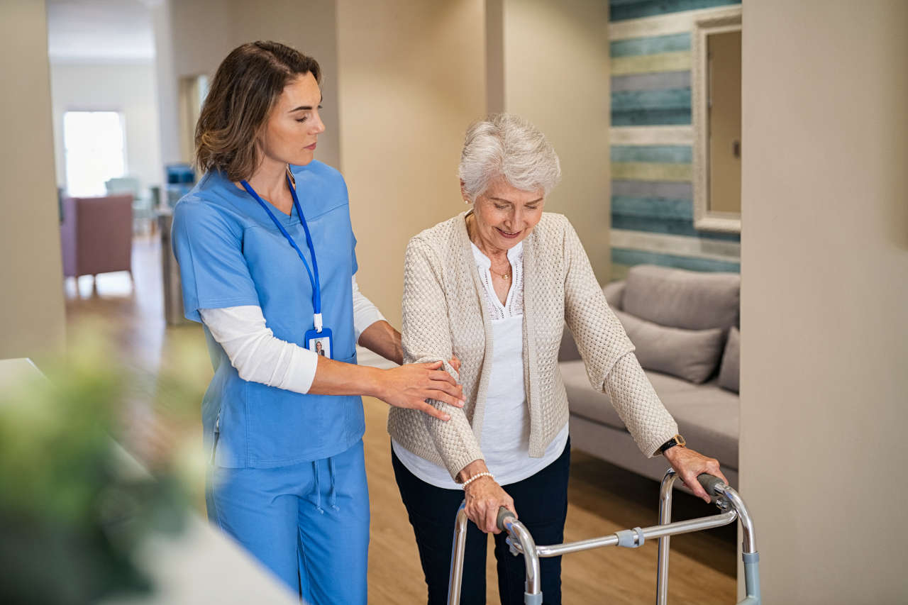 Nurse helping senior parkinson’s patient with walking