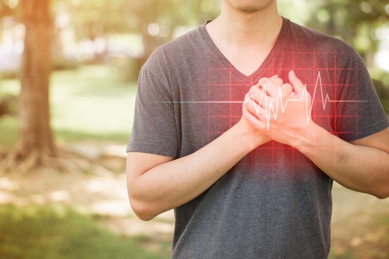 Man with heart disease holding his chest