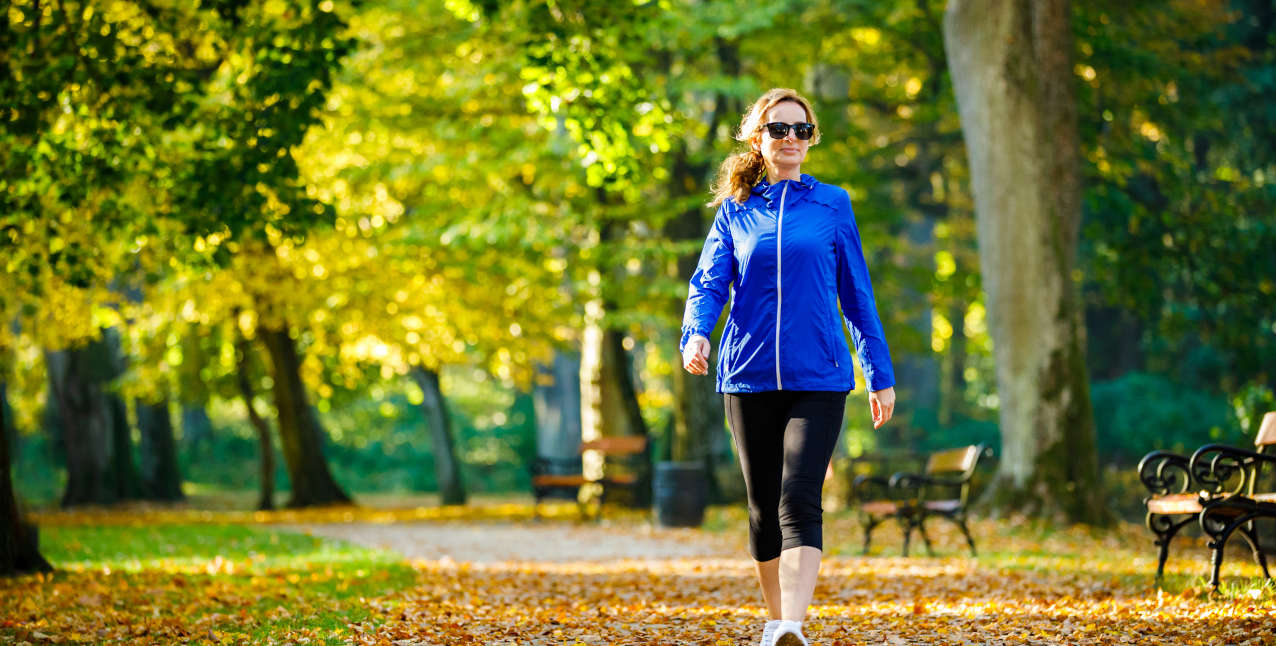 Female caregiver practicing self-care by walking in a park