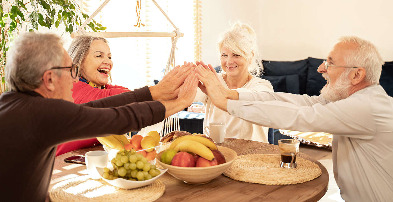 Group of senior people celebrating over healthy foods that boost energy